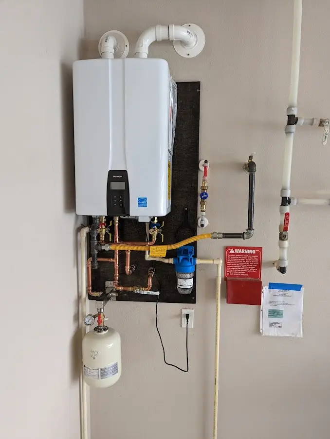 Professional plumber installing copper piping in a Malibu home